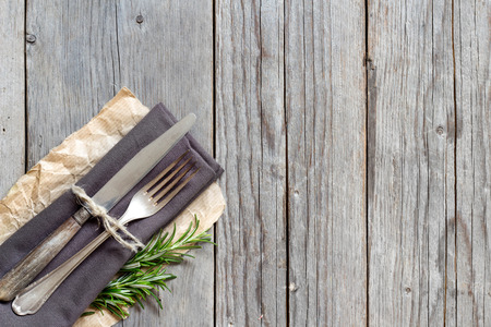 Vintage Table setting with rosemary decor on old wooden tableの写真素材