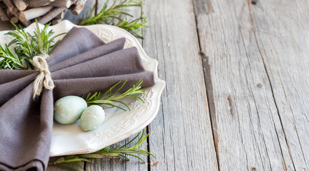 Easter table setting with eggs and rosemaryの写真素材