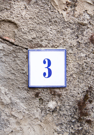 Ceramic number three on the grey stone wallの写真素材