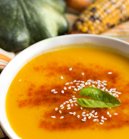 Fresh pumpkin soup with pumpkins and corn close upの写真素材