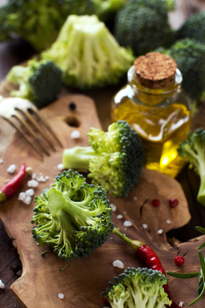 Fresh green broccoli and vegetables on wooden tableの写真素材