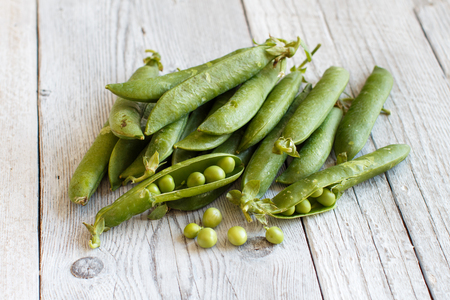 Fresh green pods from farmers market on a wooden tableの写真素材