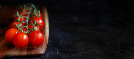 Cherry tomatoes on a dark background close upの写真素材