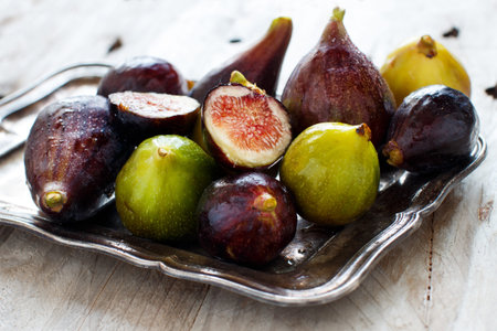 Green and purple figs  on a wooden table