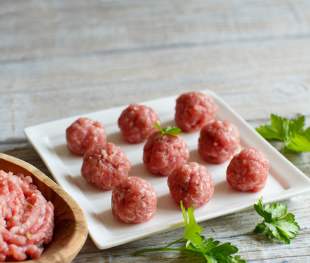 Raw  meatballs are ready to cook on a plateの写真素材