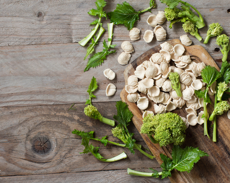 Raw homemade Orecchiette pasta and turnip greens cose upの写真素材