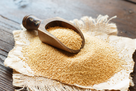 Raw Organic Amaranth grain with a spoon on wooden tableの写真素材
