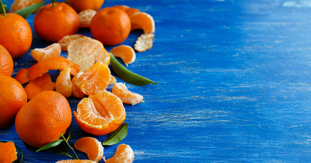 Mandarins with leaves on a bright blue background の写真素材