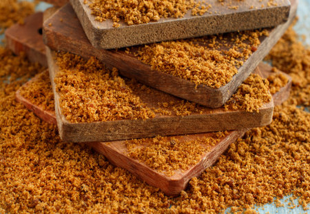 Brown unrefined cane sugar on wood close upの写真素材