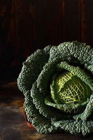 Ðaw savoy cabbage on a dark wooden tableの写真素材
