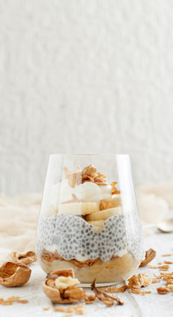 Chia pudding parfait, layered with banana and granolaの写真素材