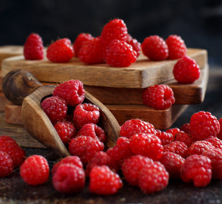 Fresh raspberries on a dark background close up