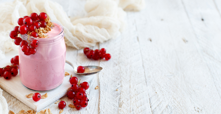 White currants and yogurt in a glass close upの写真素材