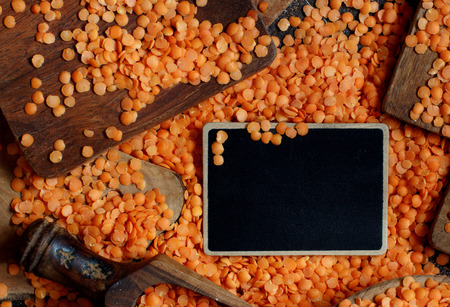 Red lentils with a small chalkboard top viewの写真素材