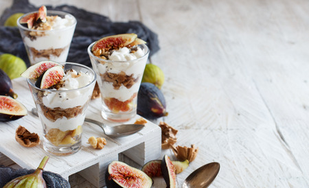 Greek yogurt with figs and granola in a glass close upの写真素材