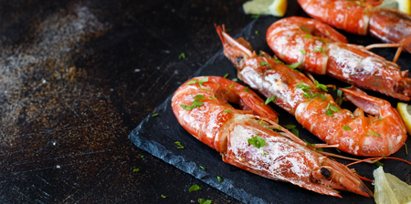 Grilled shrimps with lemon on wood close upの写真素材