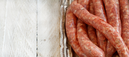 Raw Sausages on a metal tray close upの写真素材