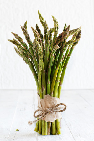 Fresh raw asparagus spears  on a dark tableの写真素材