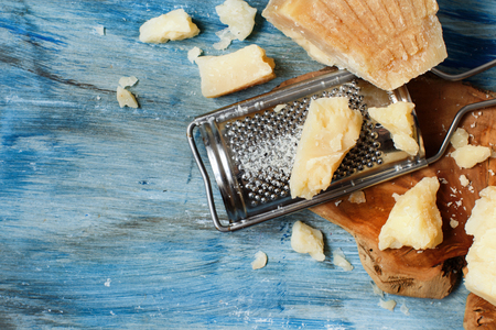 Aged parmesan cheese on a wooden table top viewの写真素材