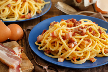 Traditional italian dish spaghetti carbonara with bacon, egg and cheeseの写真素材
