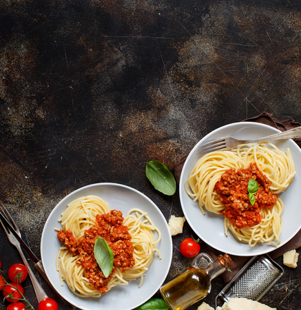 Spaghetti pasta with bolognese sauce on a dark table top viewの写真素材
