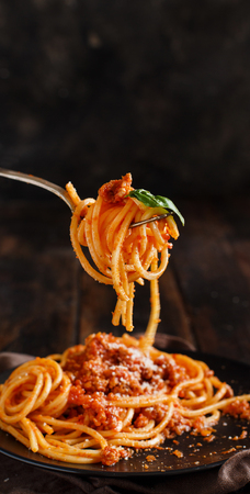 Spaghetti pasta with bolognese sauce with a fork close upの写真素材