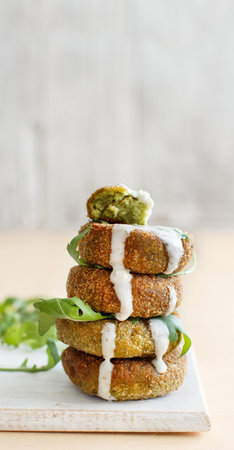 Fried vegetarian broccoli  burgers on a wooden table close upの写真素材