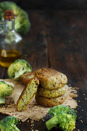 Fried vegetarian broccoli and quinoa burgers on a wooden table close upの写真素材