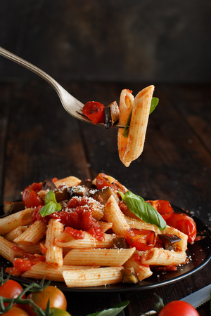 Penne alla norma  - traditional italian pasta with eggplants and tomatoesの写真素材