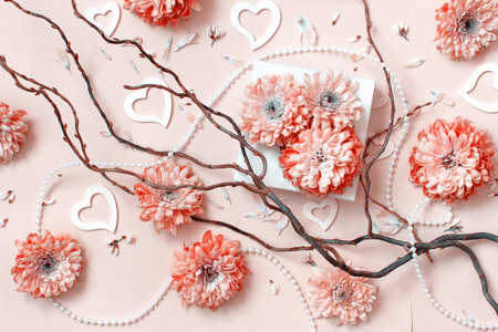 Flowers composition with hearts on a pastel pink backgroundの写真素材