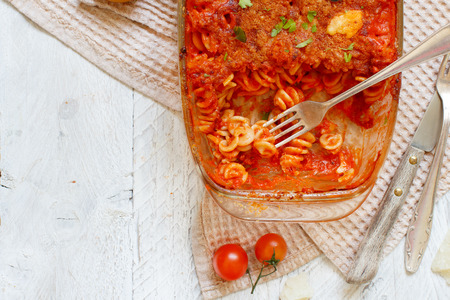 Baked fusilli pasta with tomato sauce and mozzarella cheeseの写真素材
