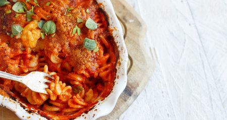 Baked fusilli pasta with tomato sauce and mozzarella cheese