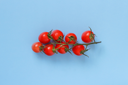 Cherry tomatoes on a blue background close upの写真素材