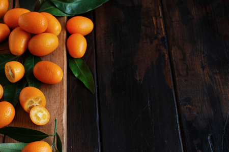 Kumquat fruits on a dark wooden background close upの写真素材