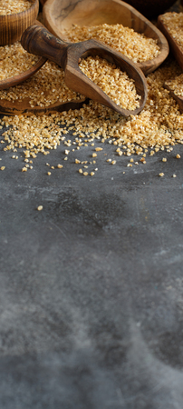 Dry bulgur wheat grains in bowls close upの写真素材