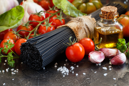 Raw squid ink pasta and vegetables close upの写真素材
