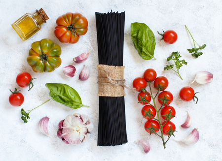 Raw squid ink pasta and vegetables top viewの写真素材