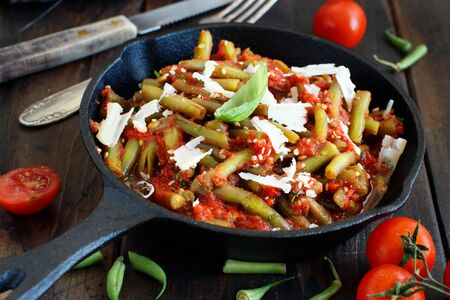 French beans with tomato stew top view on a dark tableの写真素材