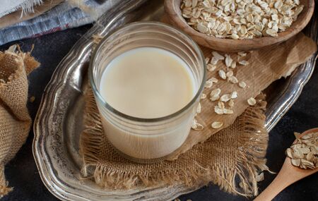 Vegan oat milk, non dairy alternative milk in a glass close upの写真素材
