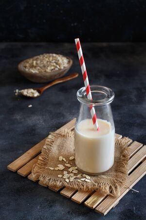 Vegan oat milk, non dairy alternative milk in a small bottle close upの写真素材