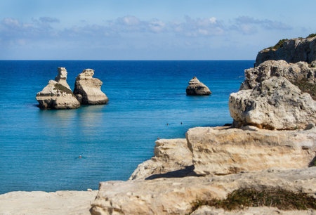 The Two Sisters stacks in front of the shore of Torre dell'Orso. Province of Lecce, Salento, Apulia,...