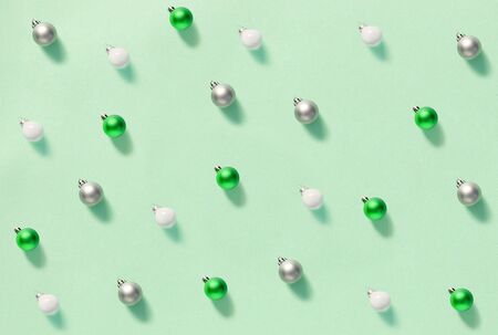 Christmas baubles on a light green background pattern top viewの写真素材
