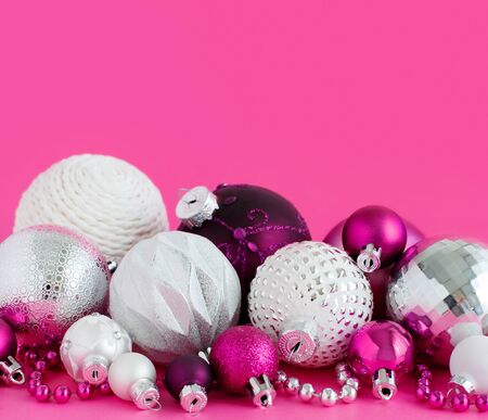 Christmas baubles on a pink background close upの写真素材