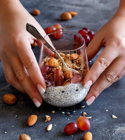 Chia pudding parfait with red grapes and almonds close upの写真素材