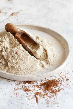 Teff flour in a plate with a spoon close upの写真素材