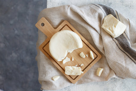 South Italian cheese cacioricotta and linen towel on a white table top view
