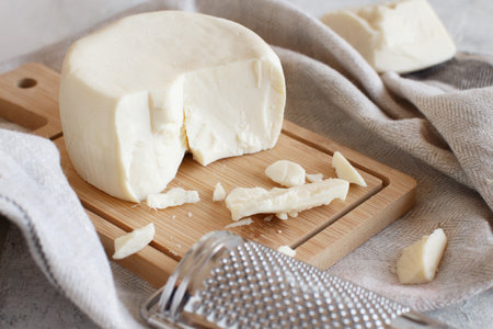 South Italian cheese cacioricotta on a wooden table close up
