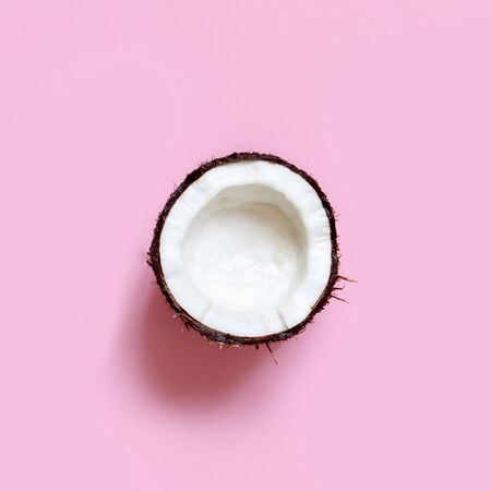 Coconut piece on a light pink background top viewの写真素材