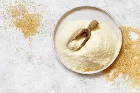 Bowl of raw Amaranth flour with a spoon of Amaranth seeds top viewの写真素材