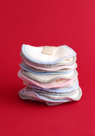 Eco friendly reusable make-up remover pads in line on red background top viewの写真素材